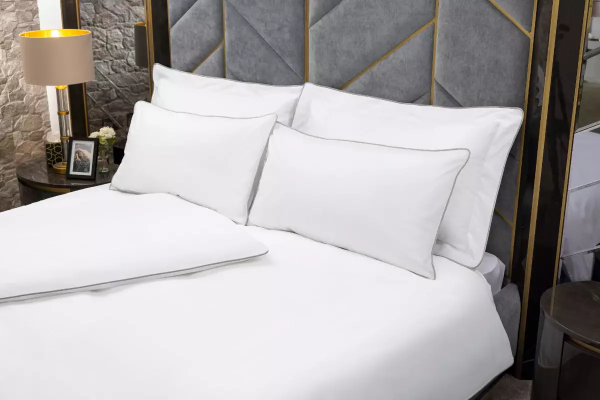Luxury bespoke linen bedding set with grey piped edging, crisp white cotton finish, and elegant hotel-style bedroom styling.
